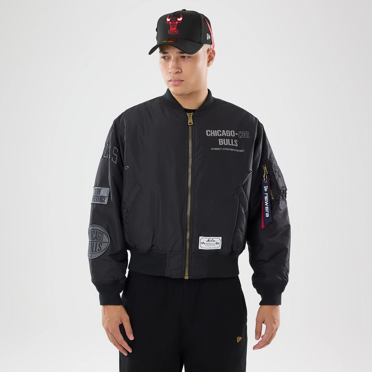 The model is wearing this NBA X Alpha Chicago Bulls Bomber Jacket & Tactical Vest in black. 1