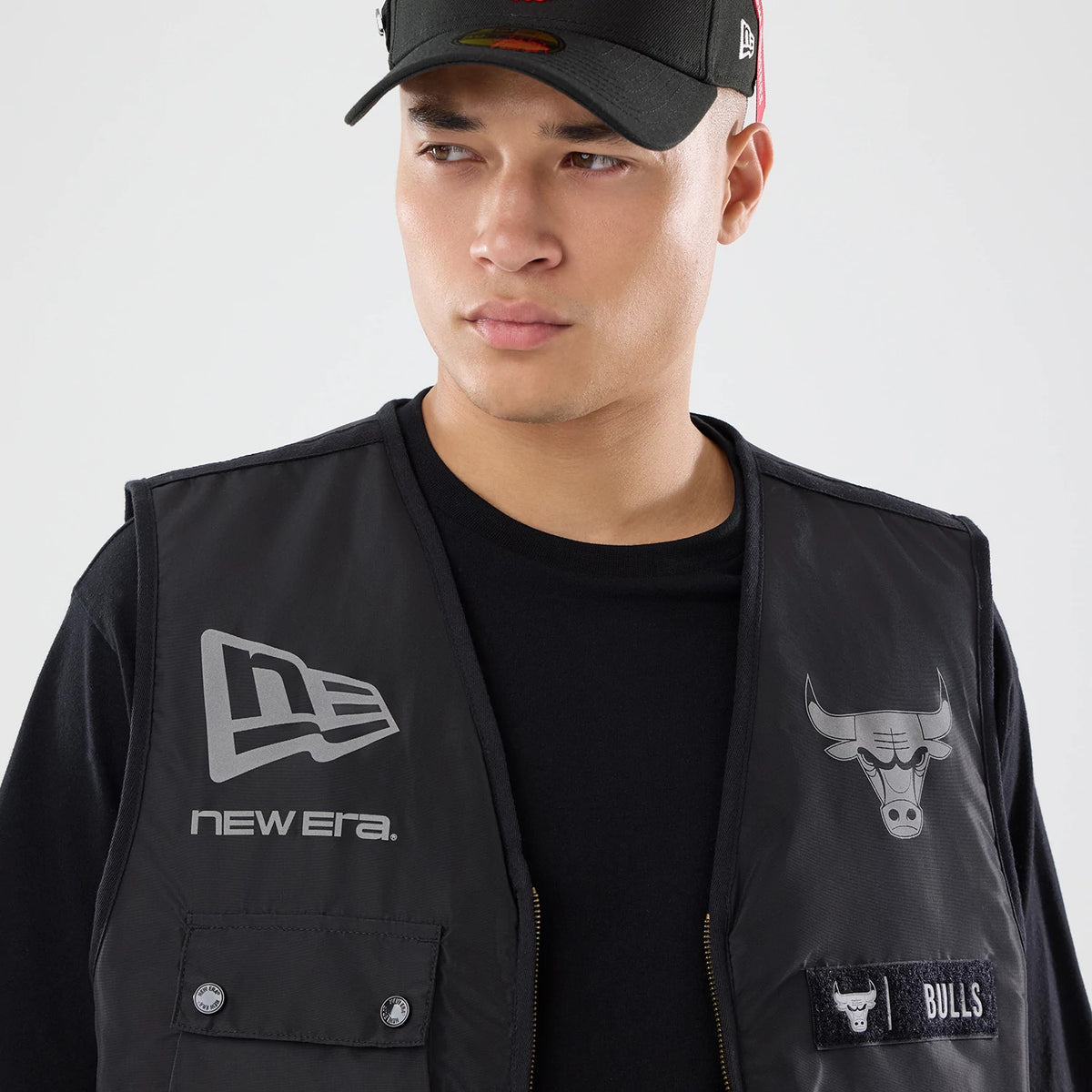 The model is wearing this NBA X Alpha Chicago Bulls Bomber Jacket & Tactical Vest in black. 7