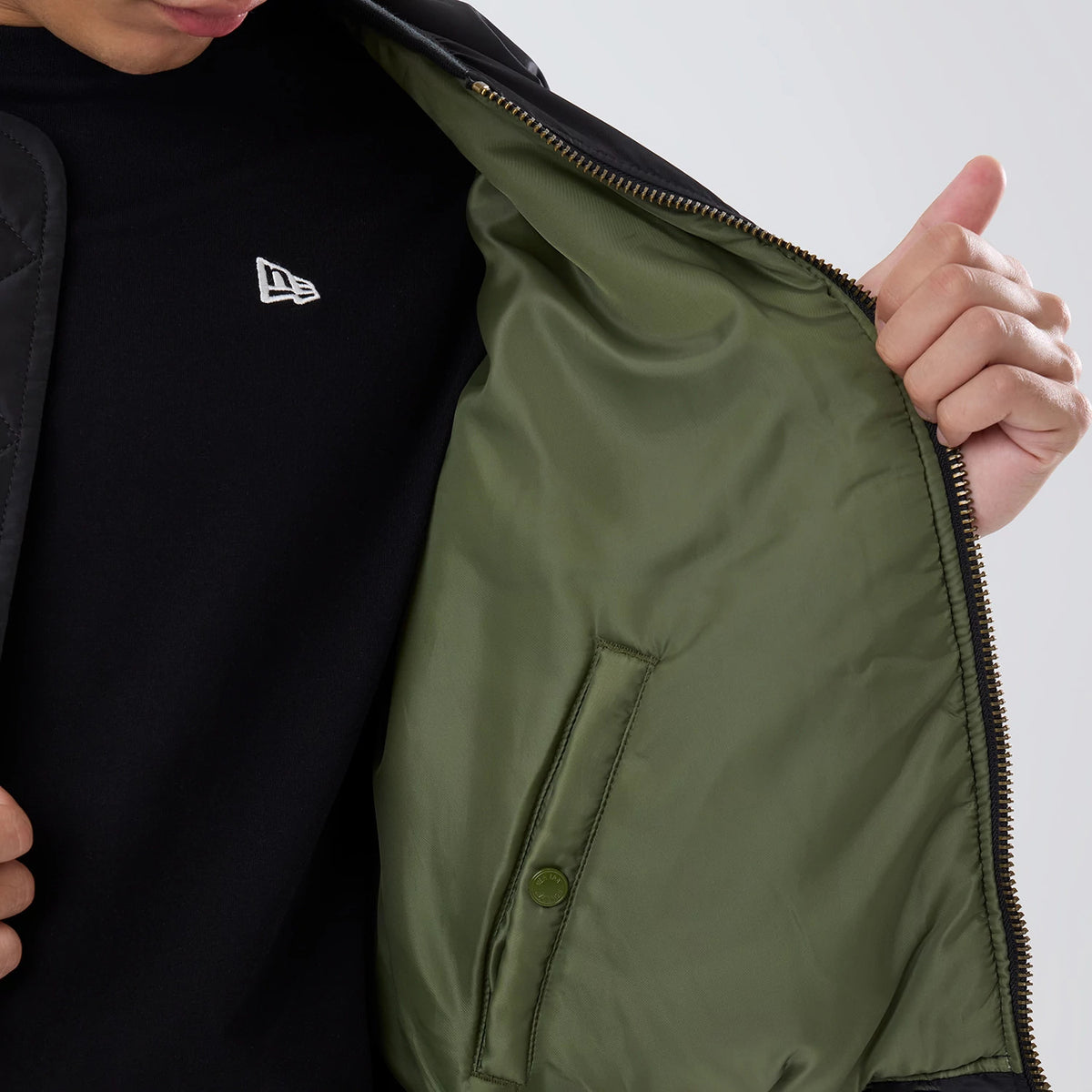 The model is wearing this NBA X Alpha Chicago Bulls Bomber Jacket & Tactical Vest in black. 6