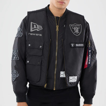 The model is wearing this NFL X Alpha Las Vegas Raiders Bomber Jacket & Tactical Vest in black. 5