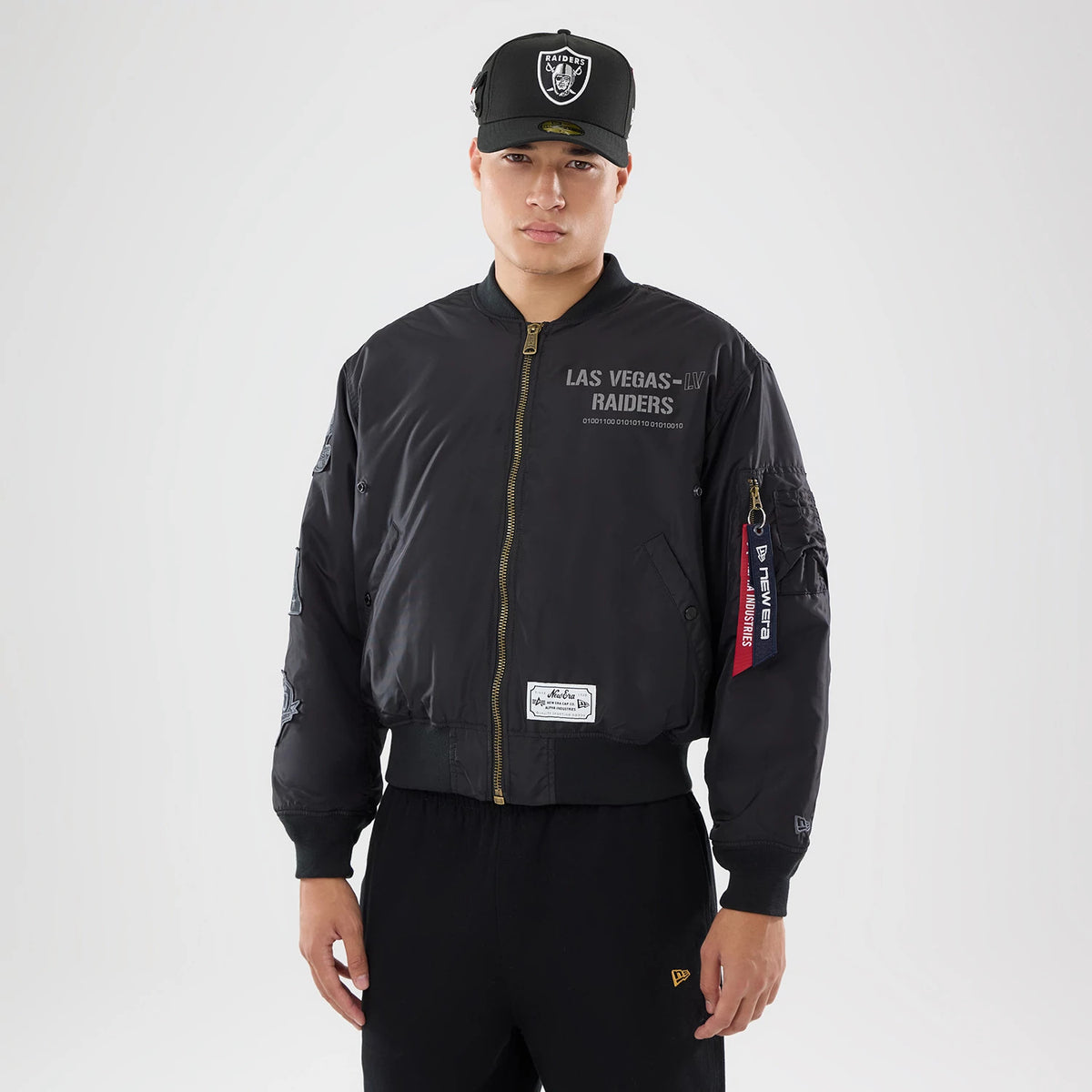 The model is wearing this NFL X Alpha Las Vegas Raiders Bomber Jacket & Tactical Vest in black. 1