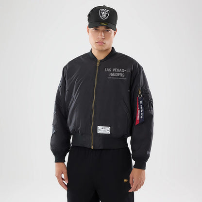 The model is wearing this NFL X Alpha Las Vegas Raiders Bomber Jacket & Tactical Vest in black. 1