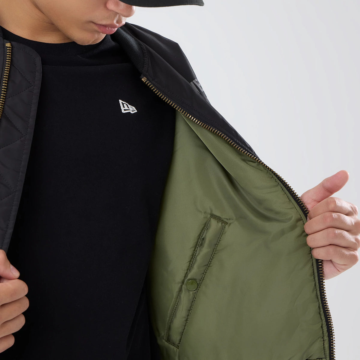 The model is wearing this NFL X Alpha Las Vegas Raiders Bomber Jacket & Tactical Vest in black. 7