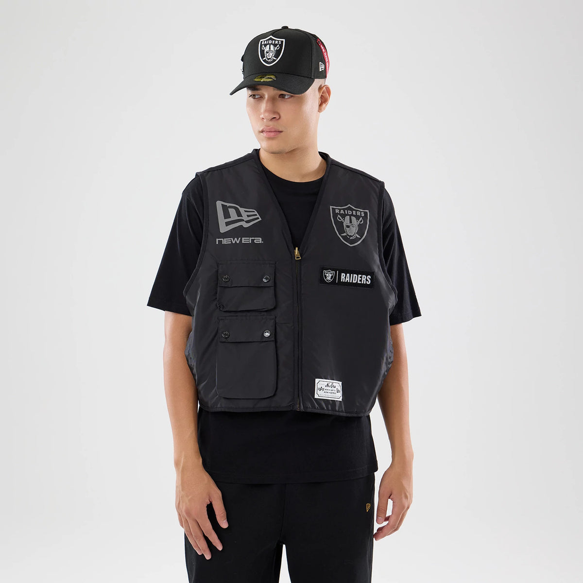 The model is wearing this NFL X Alpha Las Vegas Raiders Bomber Jacket & Tactical Vest in black. 2