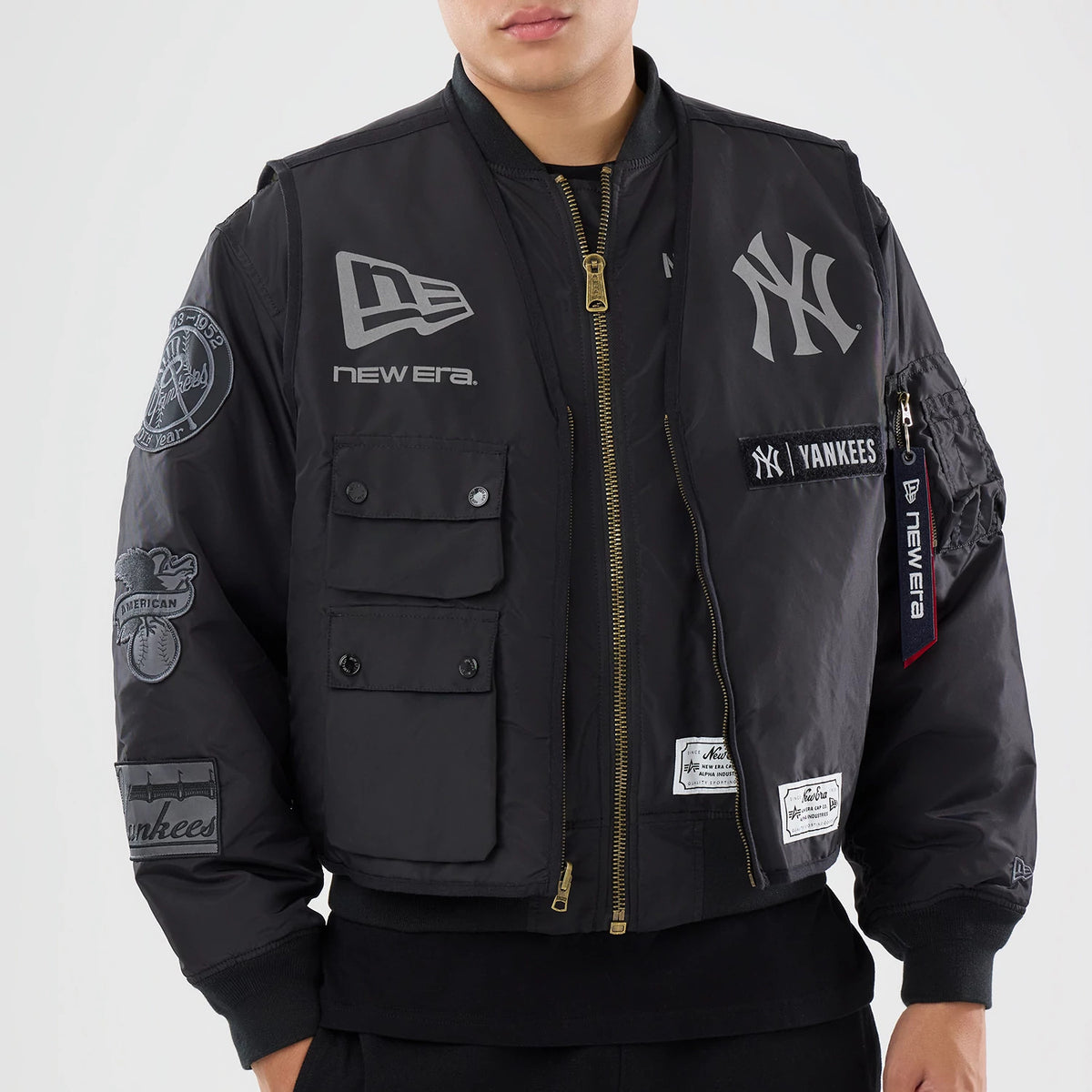 The model is wearing this MLB X Alpha New York Yankees Bomber Jacket & Tactical Vest in black. 5