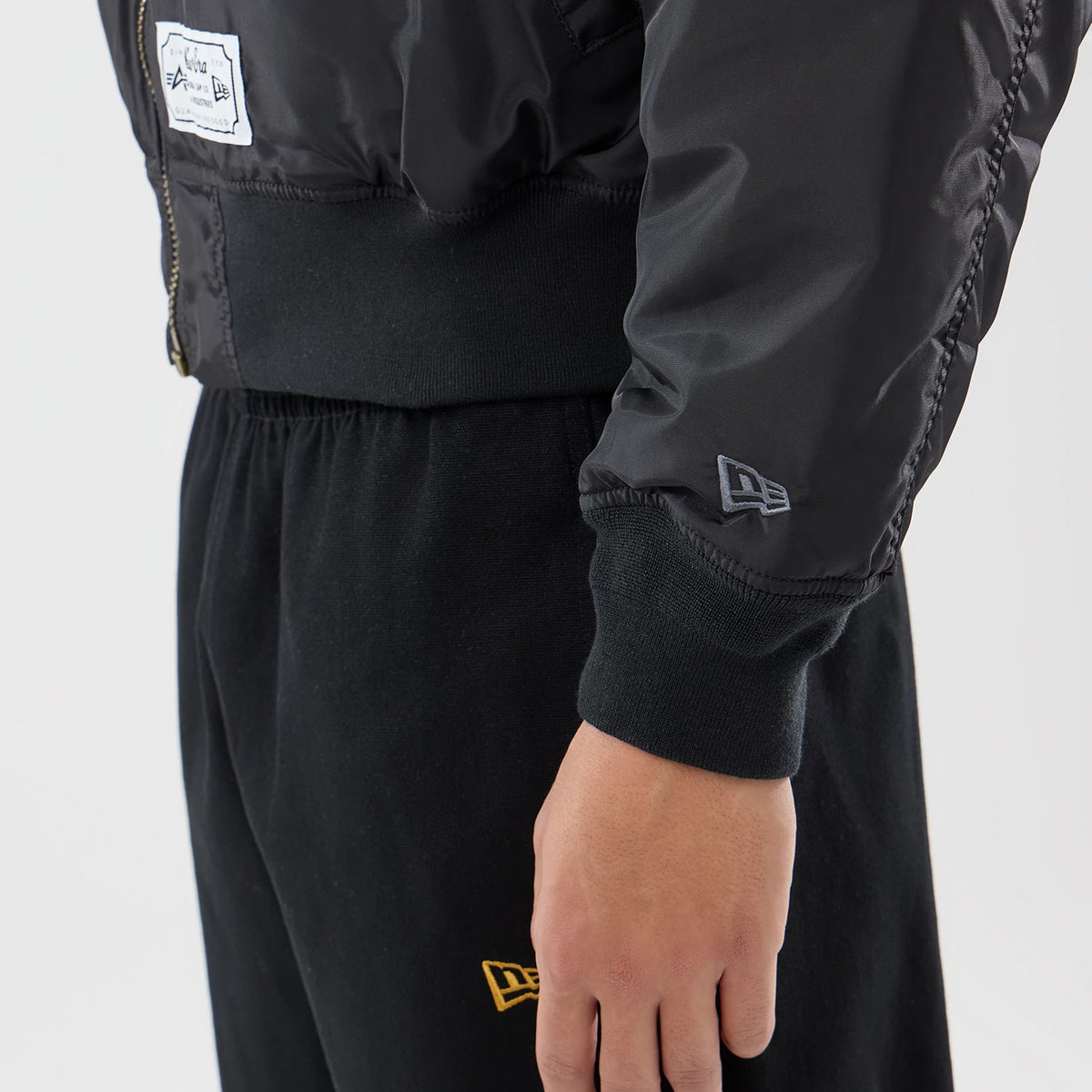 The model is wearing this MLB X Alpha New York Yankees Bomber Jacket & Tactical Vest in black. 6