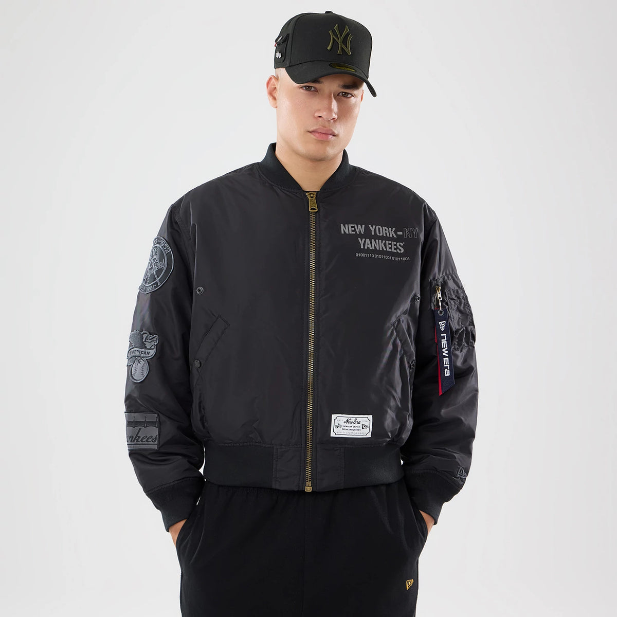 The model is wearing this MLB X Alpha New York Yankees Bomber Jacket & Tactical Vest in black. 1