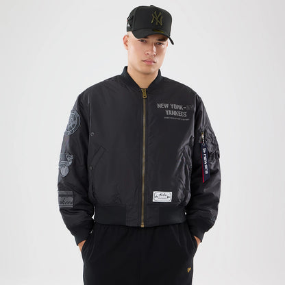 The model is wearing this MLB X Alpha New York Yankees Bomber Jacket & Tactical Vest in black. 1