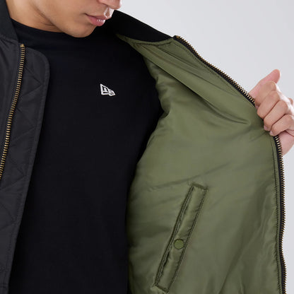 The model is wearing this MLB X Alpha New York Yankees Bomber Jacket & Tactical Vest in black. 7