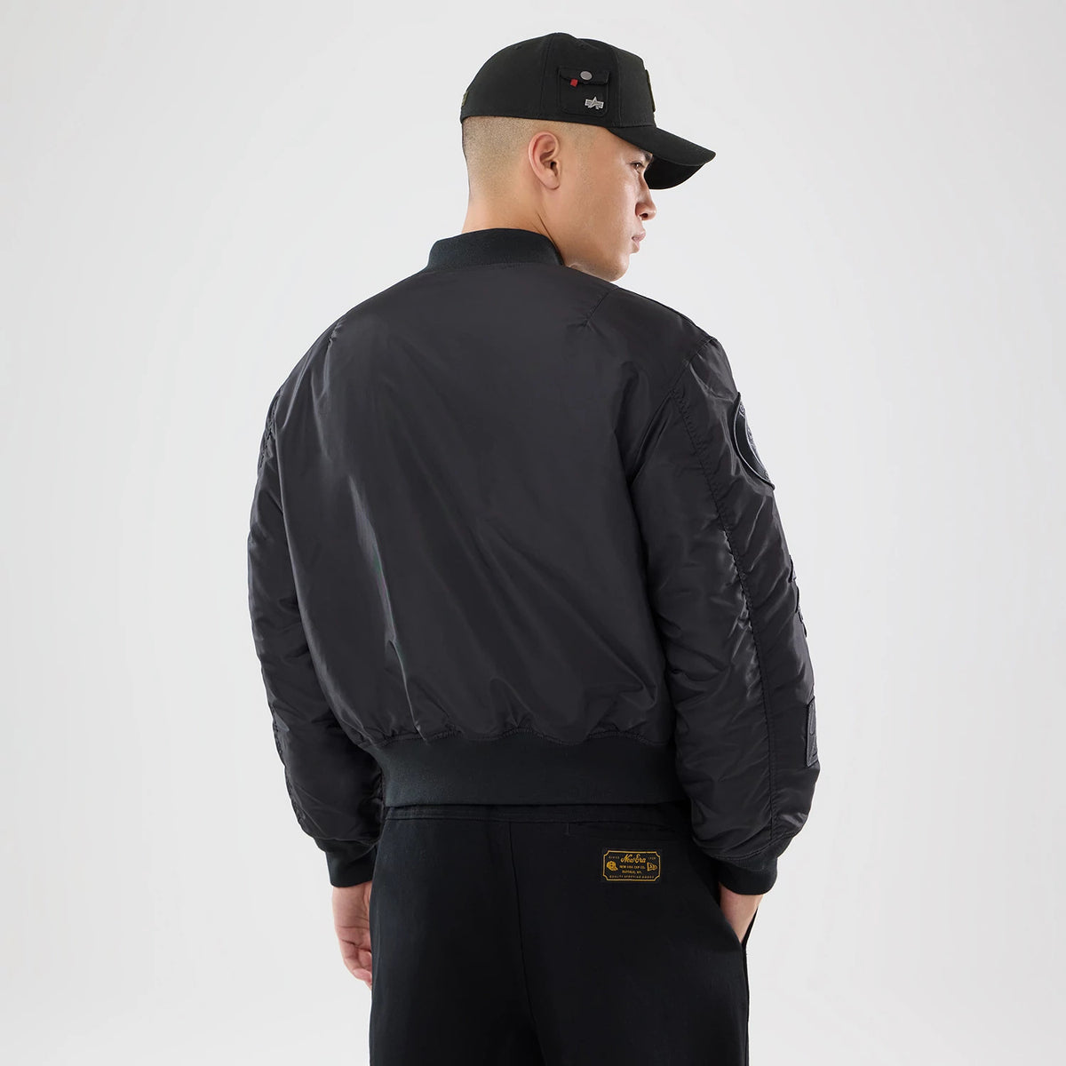 The model is wearing this MLB X Alpha New York Yankees Bomber Jacket & Tactical Vest in black. 2