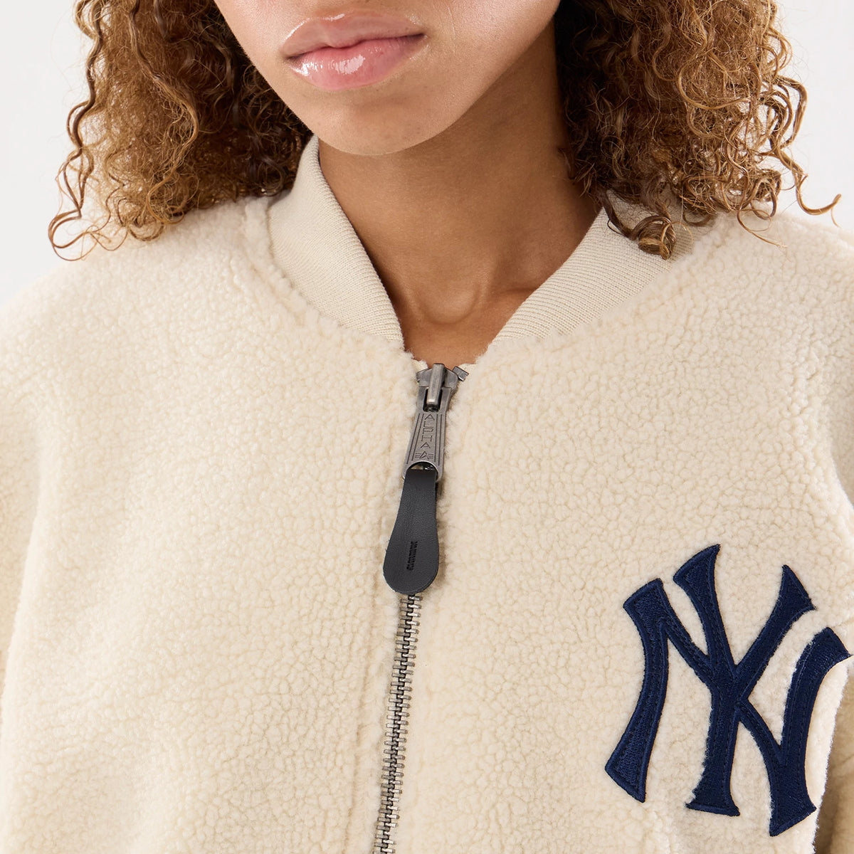 The model is wearing this MLB X Alpha New York Yankees Borg Jacket in cream. 4