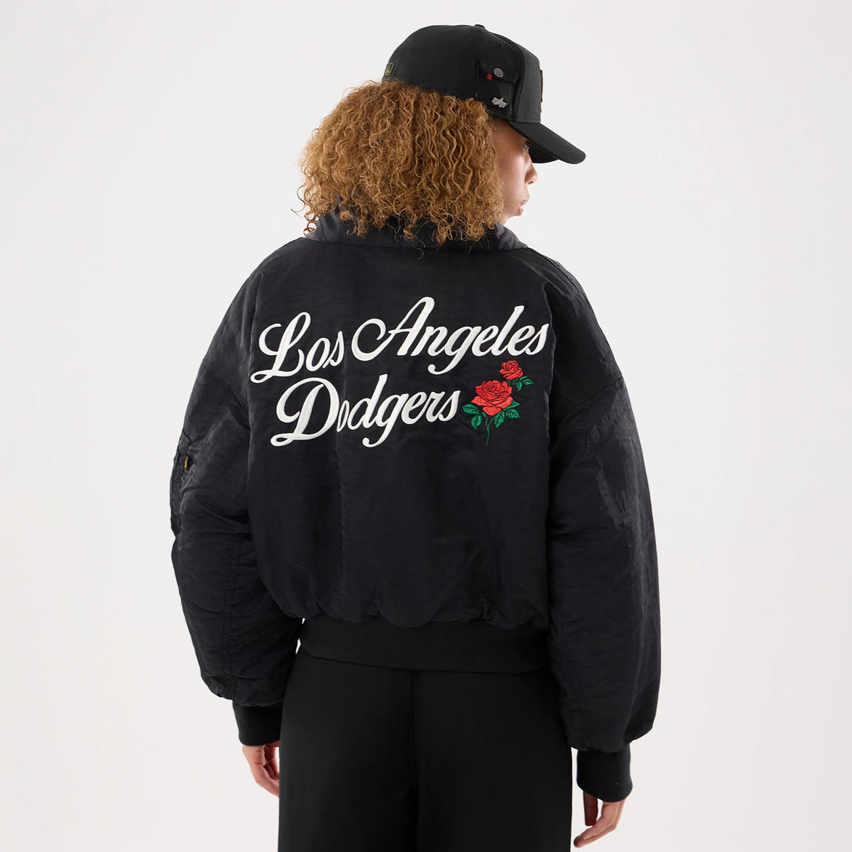 The model is wearing this MLB X Alpha LA Dodgers Jacket in black. 2