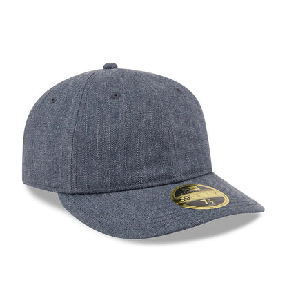 New Era Herringbone Navy Retro Crown 59FIFTY Fitted Cap, three-quarter view showing the textured herringbone pattern across the structured navy crown and flat visor, complete with a gold 59FIFTY size sticker on the visor’s top surface.