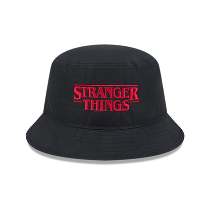 New Era Netflix Stranger Things Black Bucket Hat, front view showing red Stranger Things embroidery on the structured black crown, with a downward sloping visor that adds to its classic bucket hat silhouette.