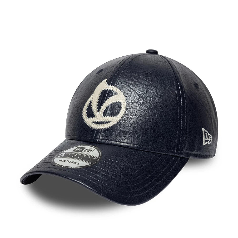 Vespa Crinkle PU Navy New Era 9FORTY Adjustable Cap, three-quarter view showing a large cream embroidered Vespa logo on the front panel, black crinkle-textured material, a New Era flag logo on the left side.