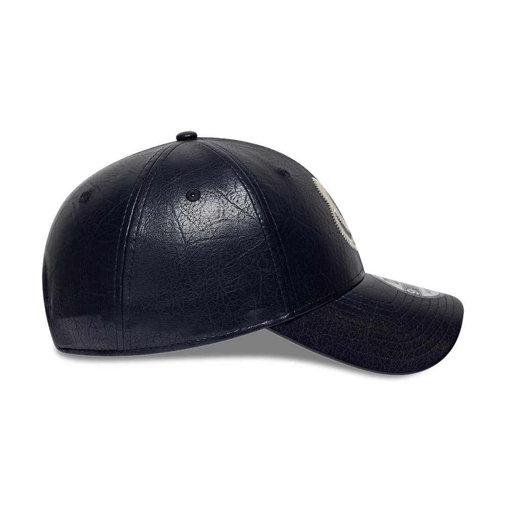 Vespa Crinkle PU Navy New Era 9FORTY Adjustable Cap, side view showing the textured navy crinkle PU material across the structured crown and curved visor, with a white emblem partially on the front panel and a 9FORTY size sticker on the visor.