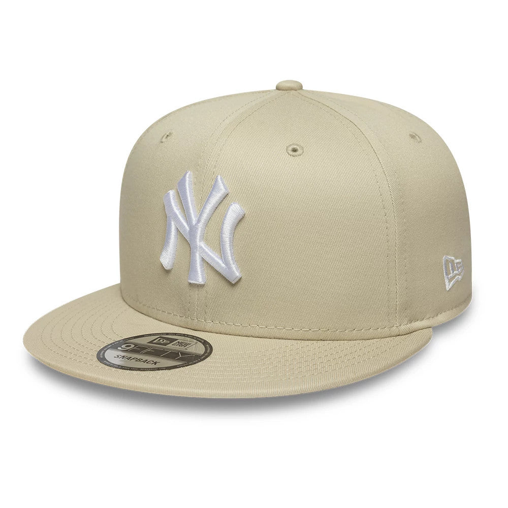 New York Yankees MLB League Essential Light Beige New Era 9FIFTY Snapback Adjustable Cap, three-quarter view showing the raised white embroidered NY logo on the front panel, the matching light beige flat visor.