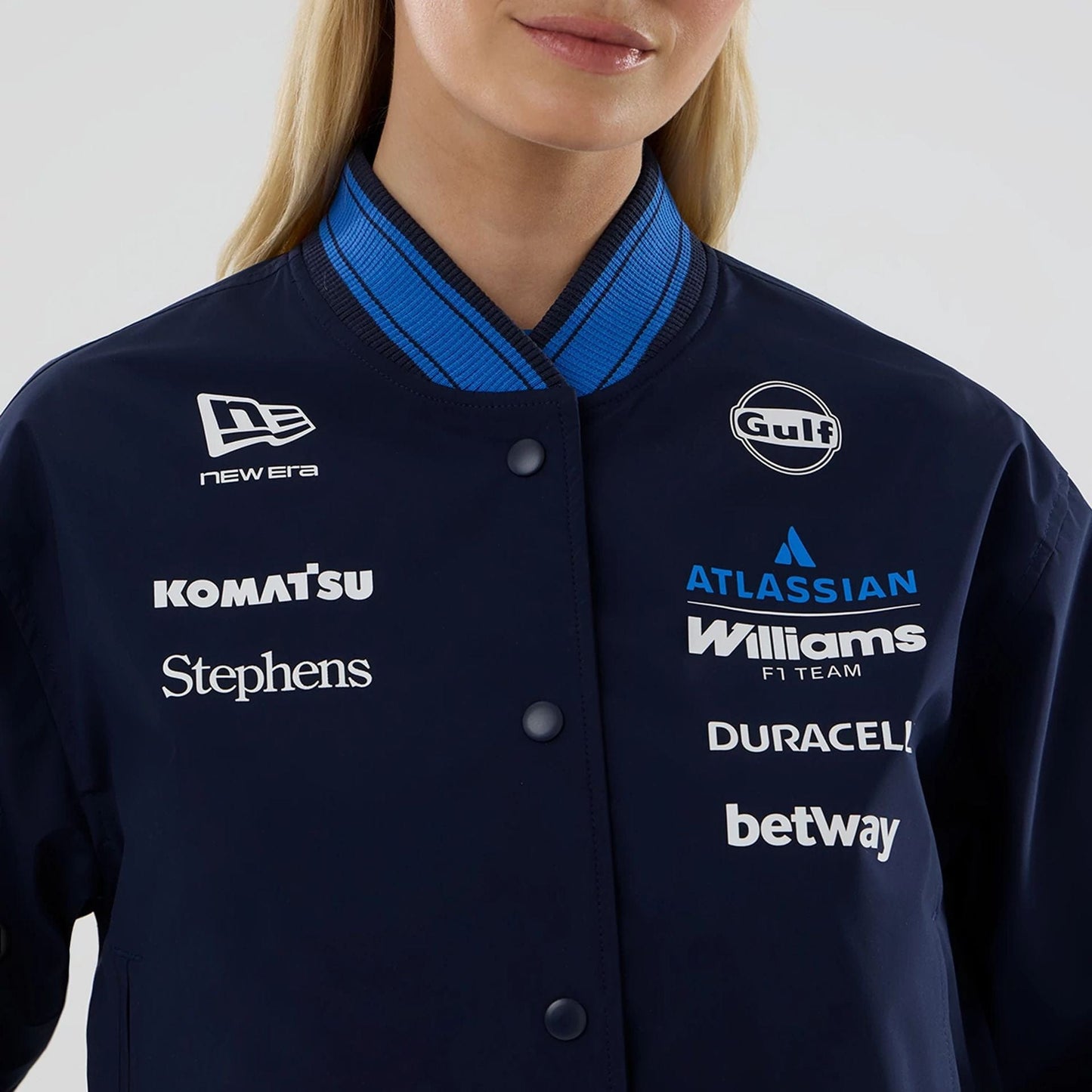 The model is wearing this Womens Atlassian Williams F1 Team Varsity Jacket in navy. 3