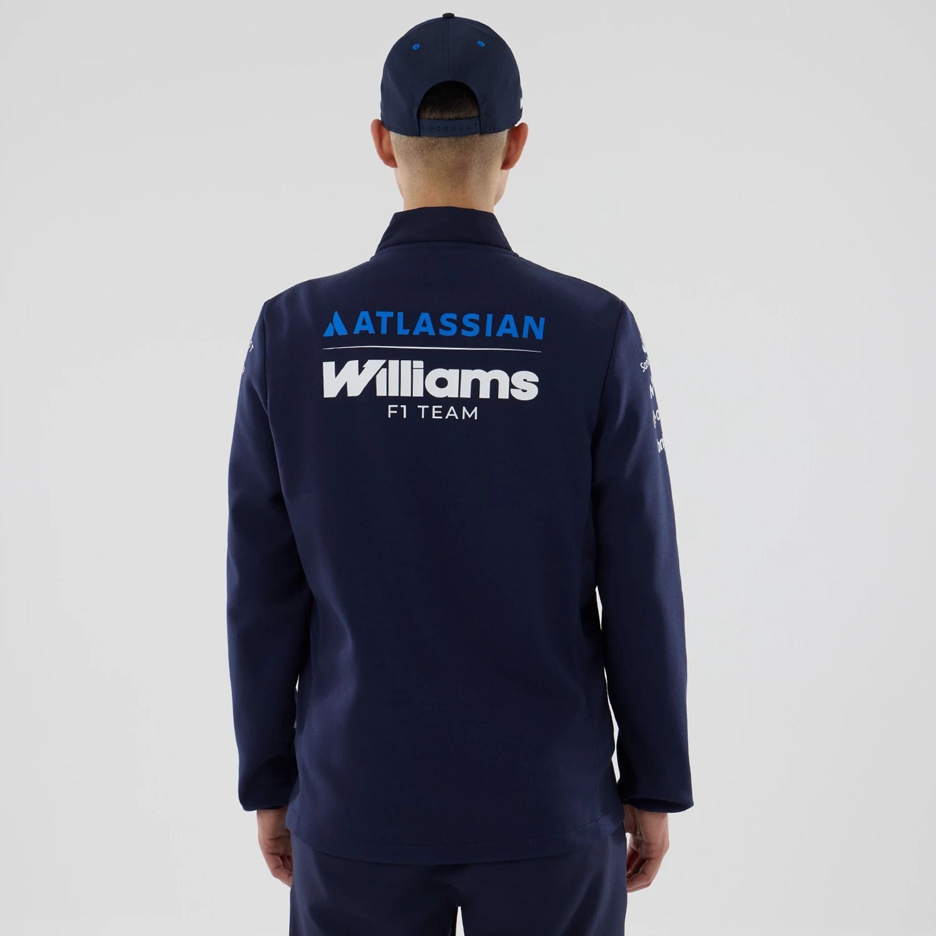 The model is wearing this Atlassian Williams F1 Team Hybrid Jacket in navy. 2