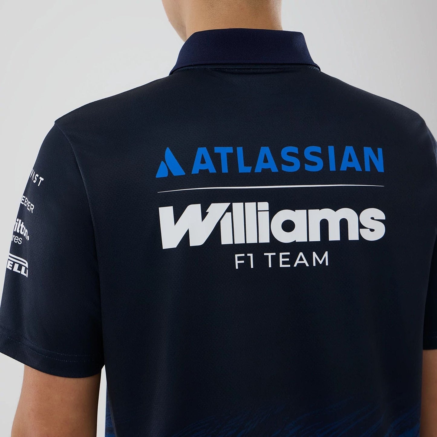 The model is wearing this Atlassian Williams F1 Team Tech Polo T-shirt in navy. 7