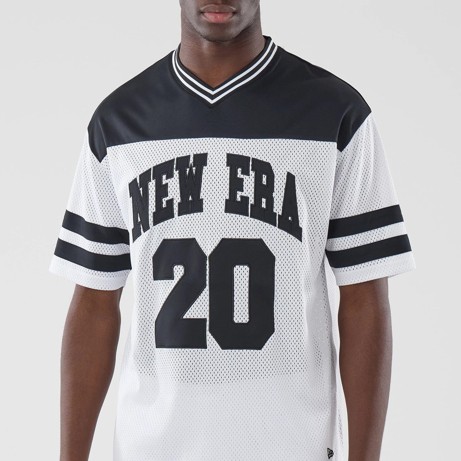 The model is wearing this New Era Mesh Oversized T-Shirt in white. 3