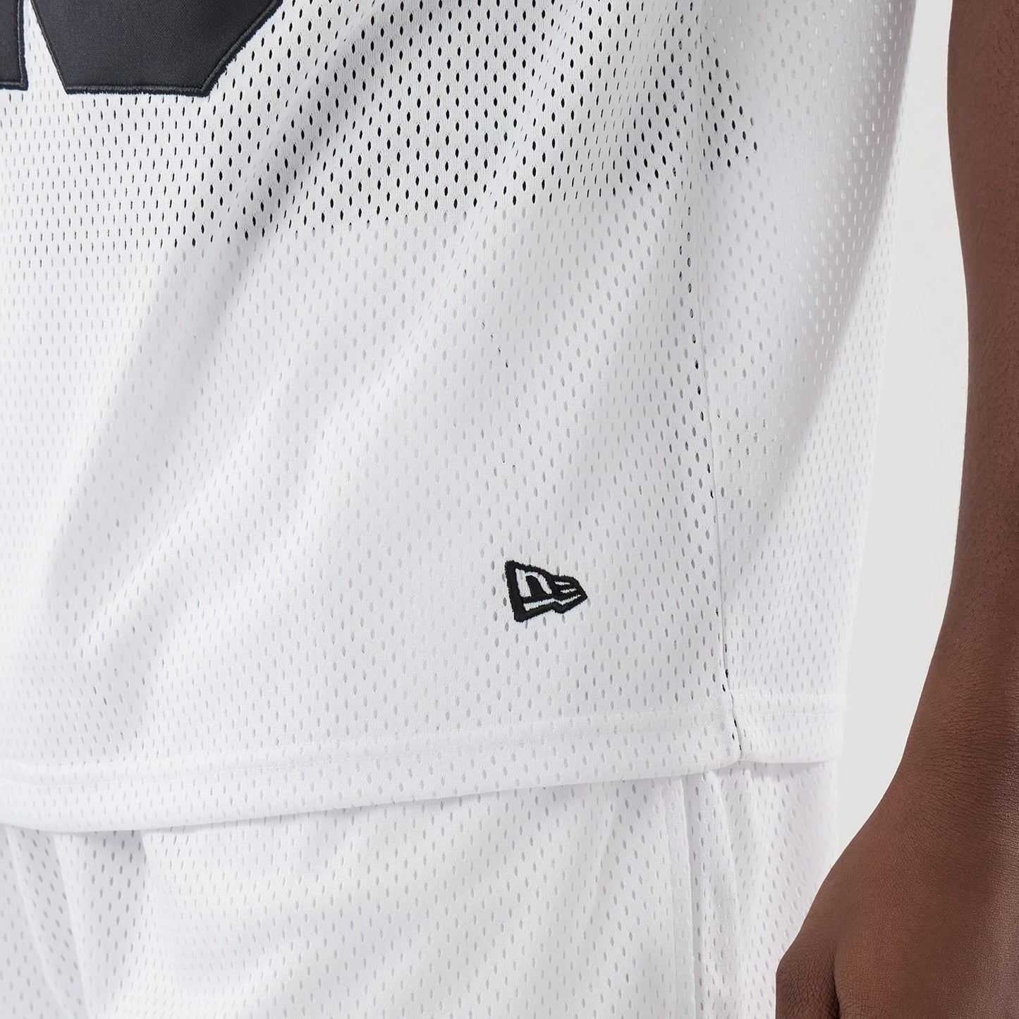 The model is wearing this New Era Mesh Oversized T-Shirt in white. 5