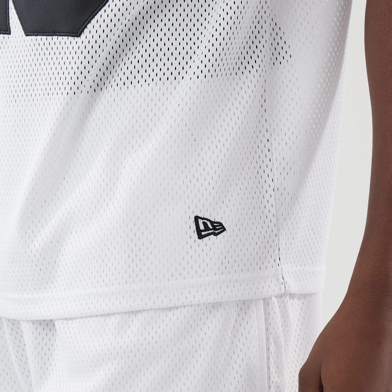 The model is wearing this New Era Mesh Oversized T-Shirt in white. 5