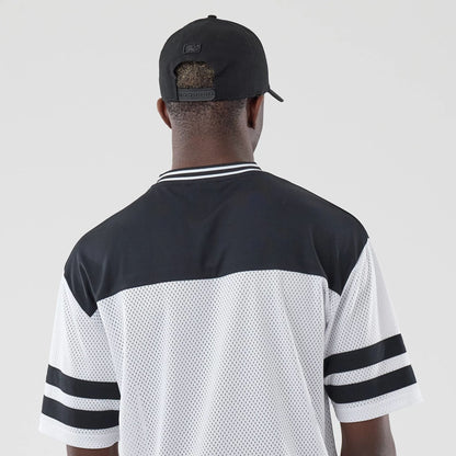The model is wearing this New Era Mesh Oversized T-Shirt in white. 7