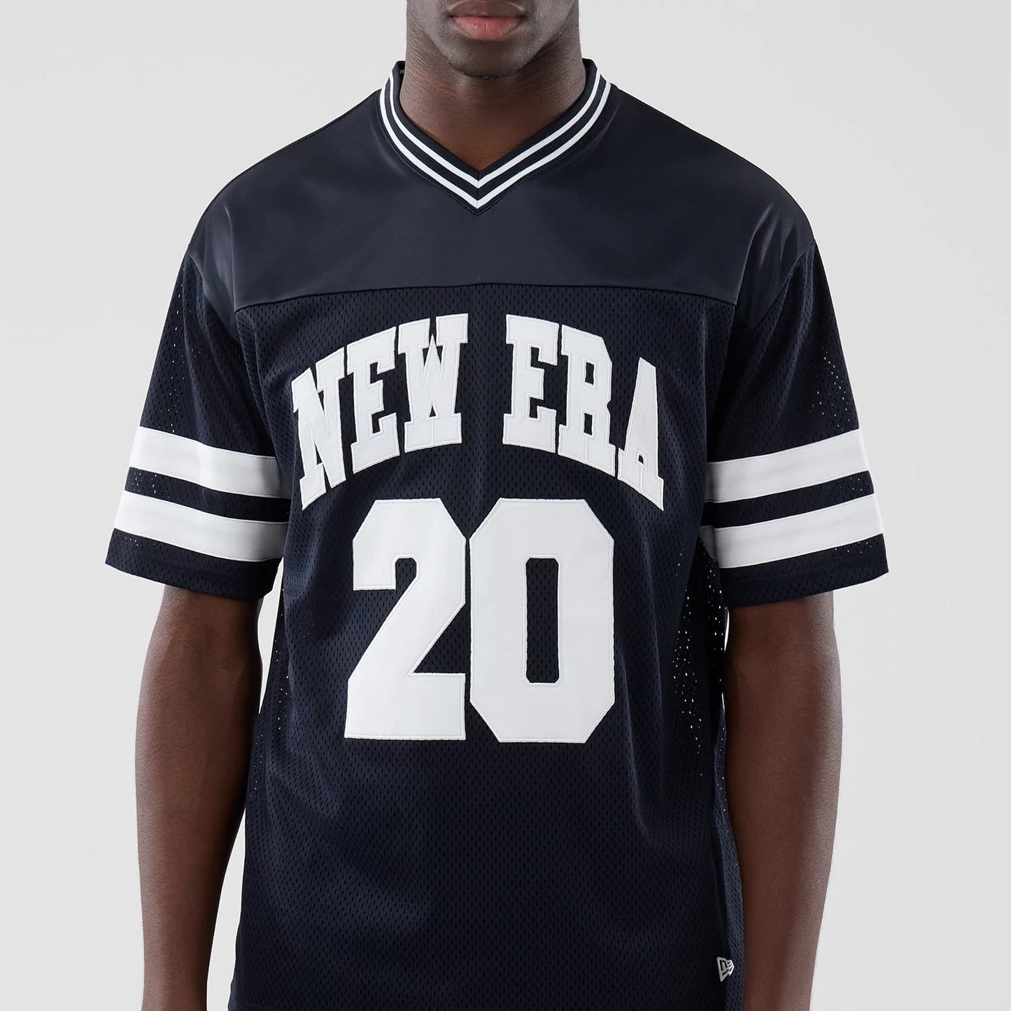 The model is wearing this New Era Mesh Oversized T-Shirt in navy. 3