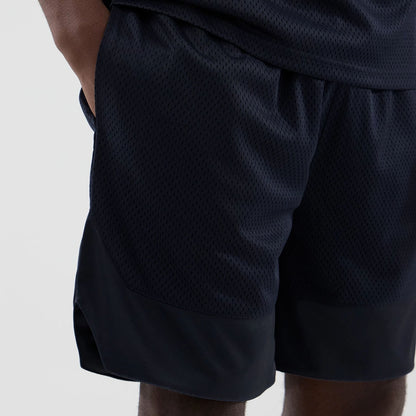 The model is wearing this New Era Mesh Oversized Shorts in navy. 3