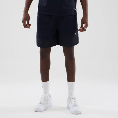 The model is wearing this New Era Mesh Oversized Shorts in navy. 5