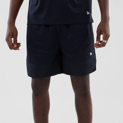 The model is wearing this New Era Mesh Oversized Shorts in navy. 6