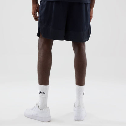 The model is wearing this New Era Mesh Oversized Shorts in navy. 2
