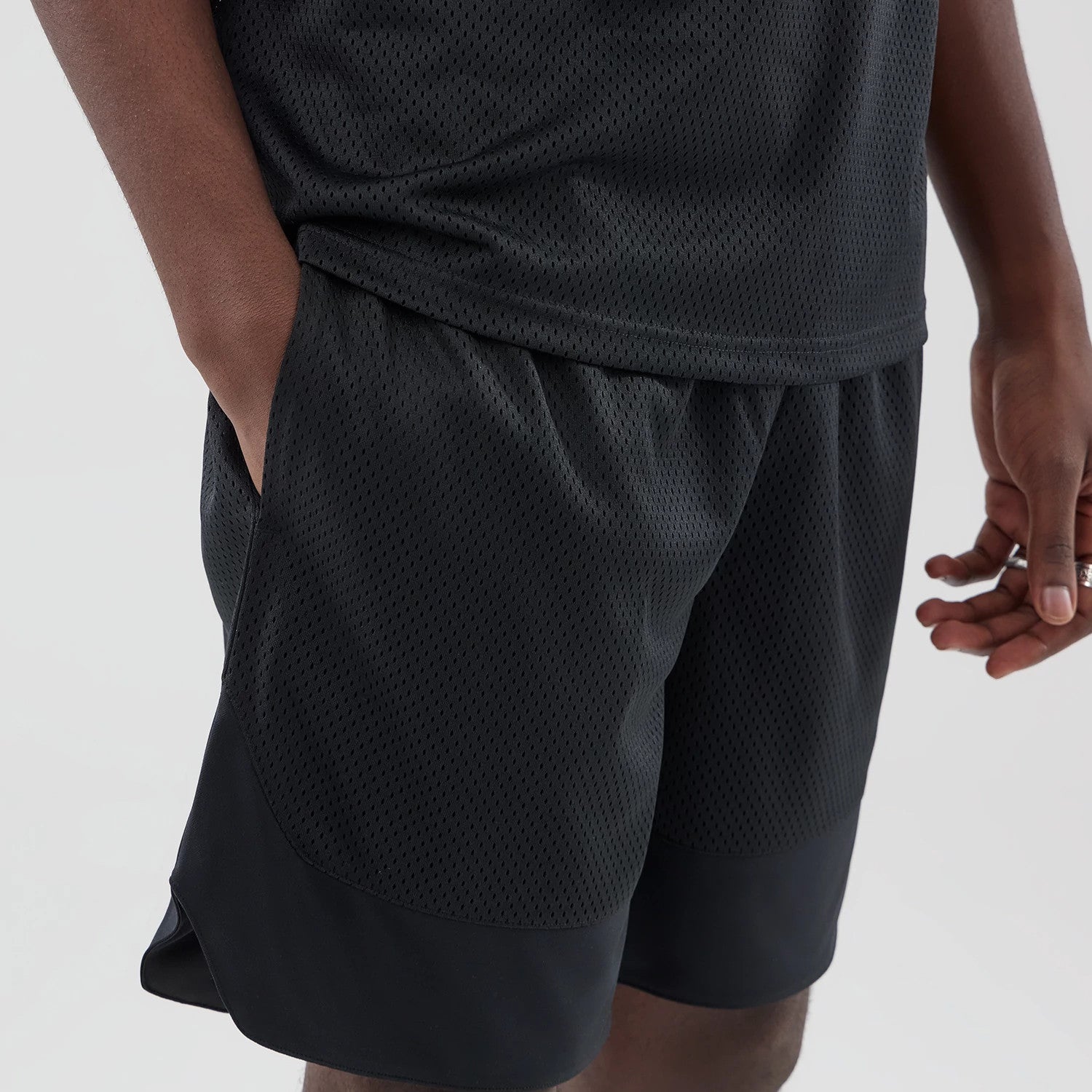 The model is wearing this New Era Mesh Stripe Oversized Shorts in black. 4