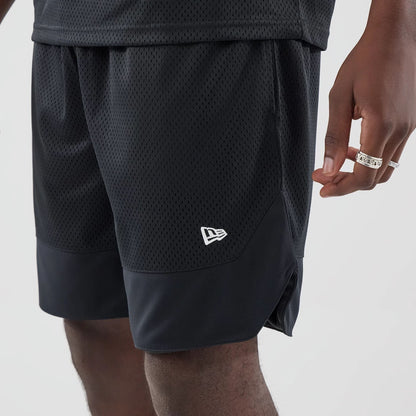 The model is wearing this New Era Mesh Oversized Shorts in black. 5