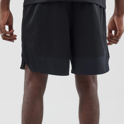 The model is wearing this New Era Mesh Stripe Oversized Shorts in black. 7