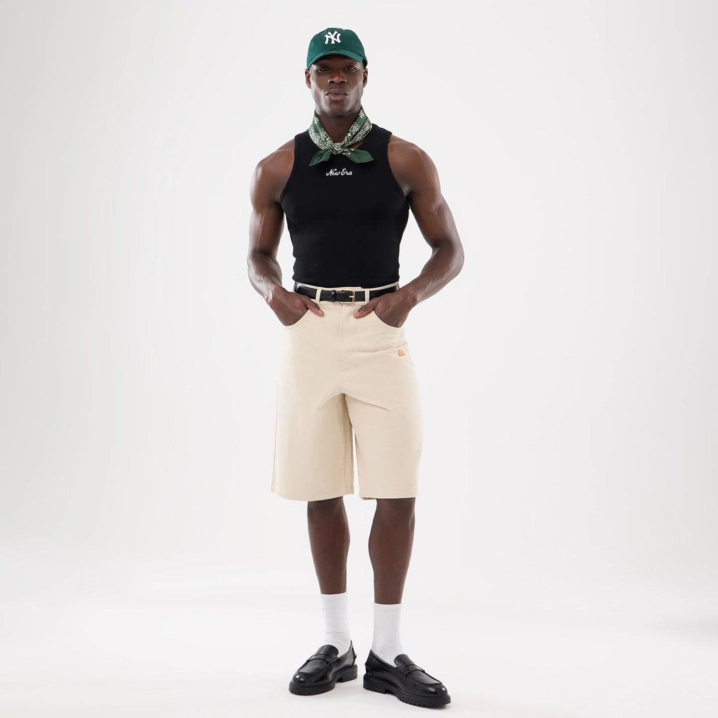The model is wearing this New Era Rib Vest in black. 12