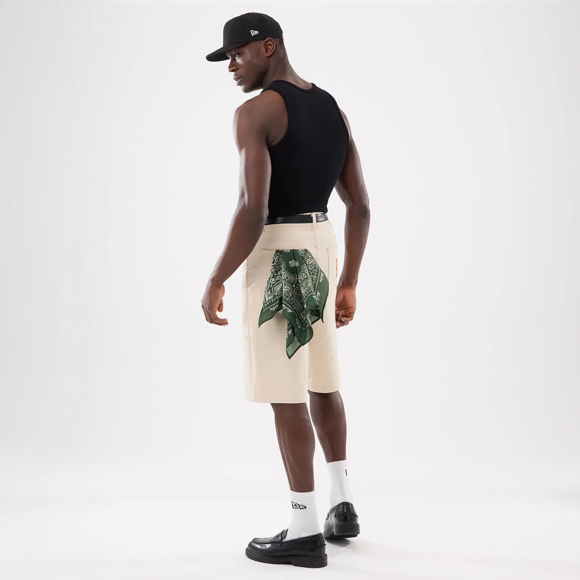 The model is wearing this New Era Rib Vest in black. 17