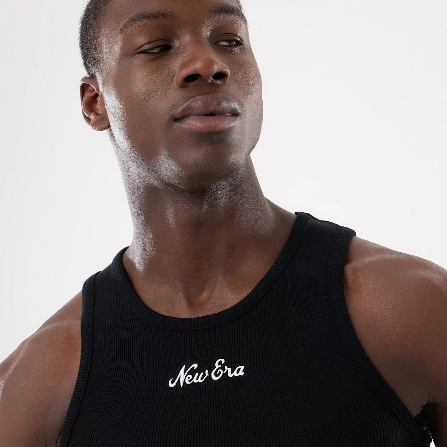 The model is wearing this New Era Rib Vest in black. 10