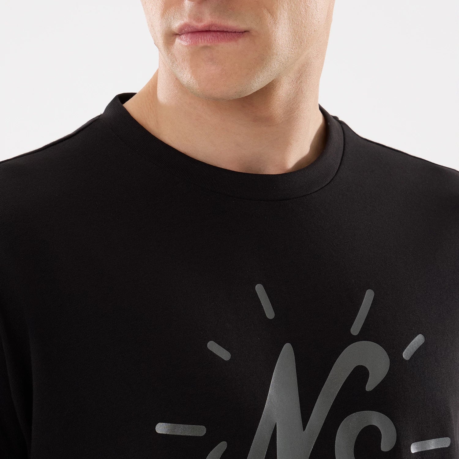 The model is wearing this New Era 59FIFTY Day Graphic T-Shirt in black. 4