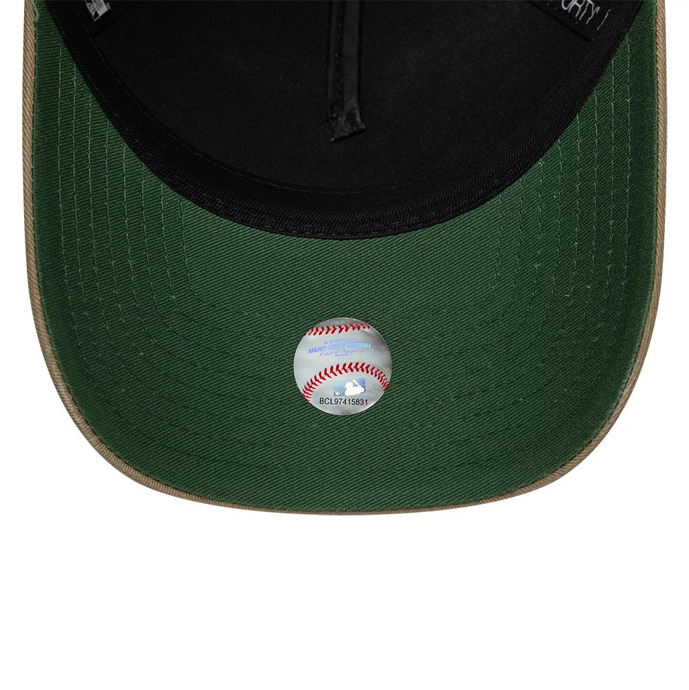 New York Yankees MLB Vibrant Festivities Beige New Era 9FORTY A-Frame Adjustable Cap, inside view showing a green undervisor, black sweatband with white lettering, and MLB authentication sticker resembling a baseball on the centre of the undervisor.