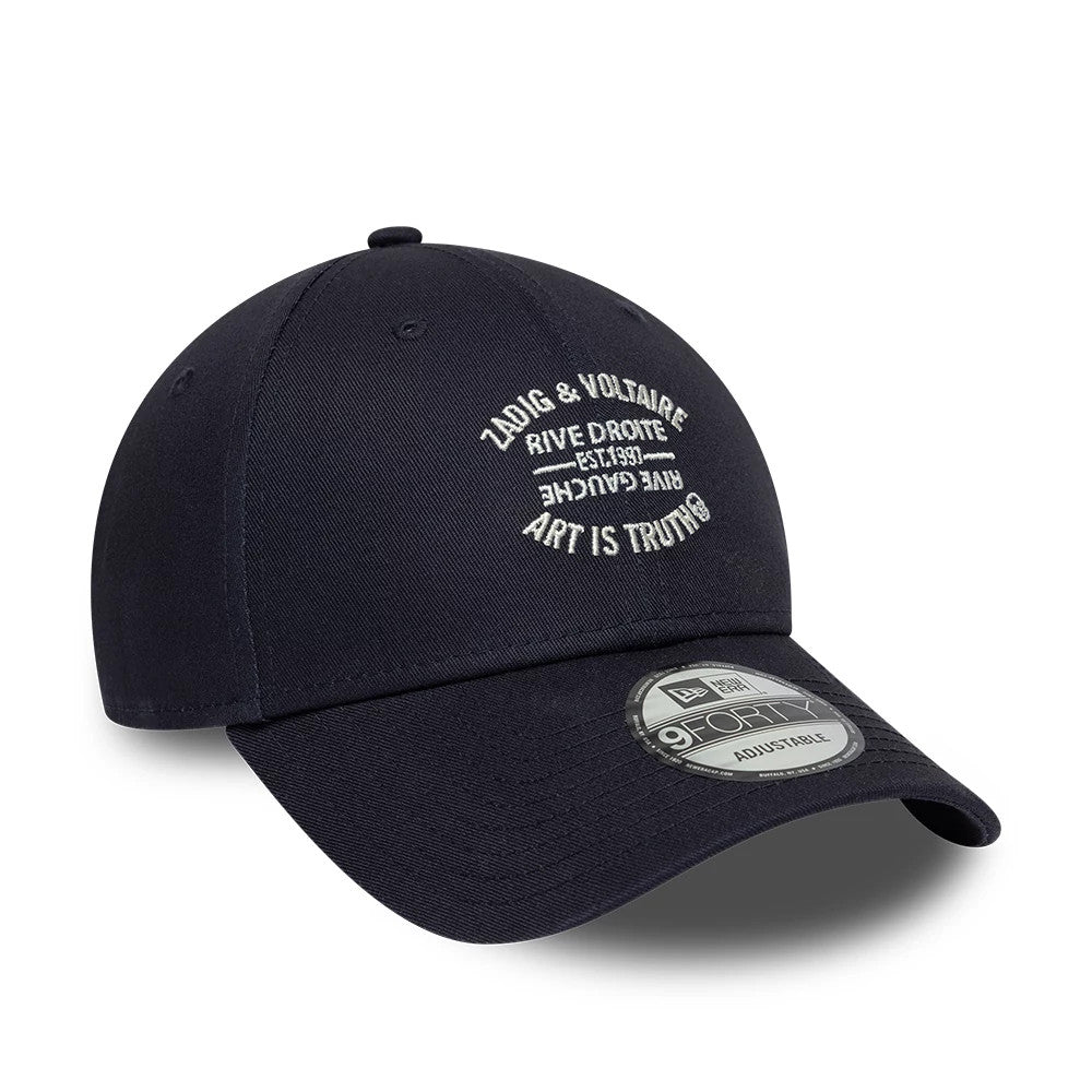 New Era X Zadig & Voltaire Resort Navy 9FORTY Adjustable Cap, three-quarter view showing white embroidered branding on the front panel, a curved navy visor with a 9FORTY size sticker, and a top button with matching eyelets.