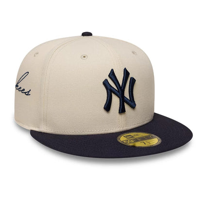 Pictured is this MLB Side Script New York Yankees 59FIFTY Fitted cap in Cream. 1