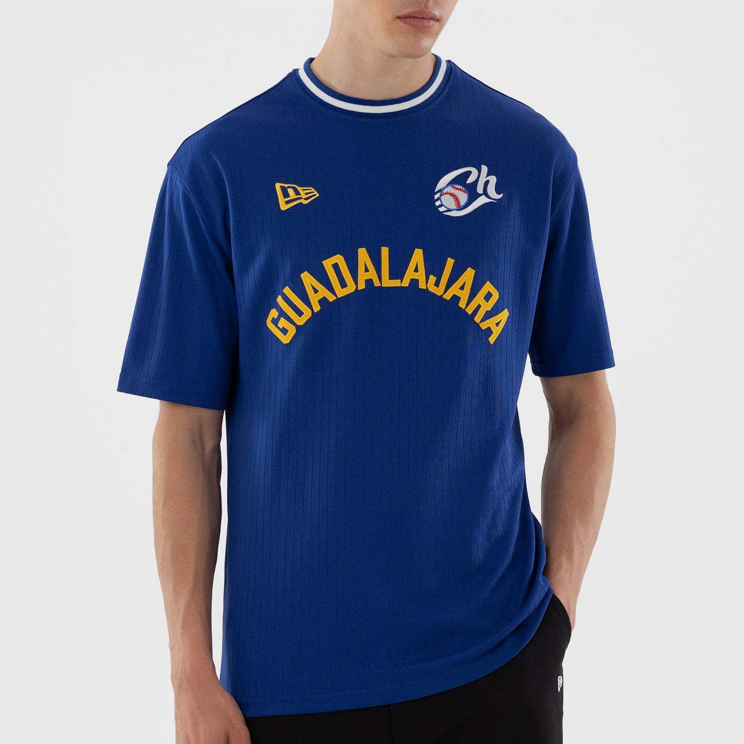 The model is wearing this LMB Charros De Jalisco Oversized T-Shirt in blue. 4