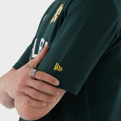 The model is wearing this MLB Athletics Oversized T-Shirt in dark green. 6