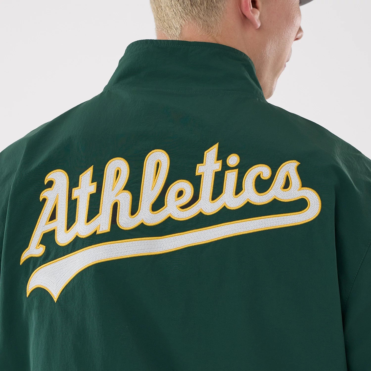 The model is wearing this MLB Athletics Sports Jacket in dark green. 4