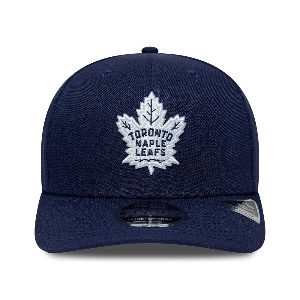 Toronto Maple Leafs NHL Team Navy New Era 9SEVENTY Stretch Snap Adjustable Cap, front view showing the raised embroidered white leaf logo on the structured navy crown, with a curved visor featuring a 9SEVENTY size sticker on the visor.