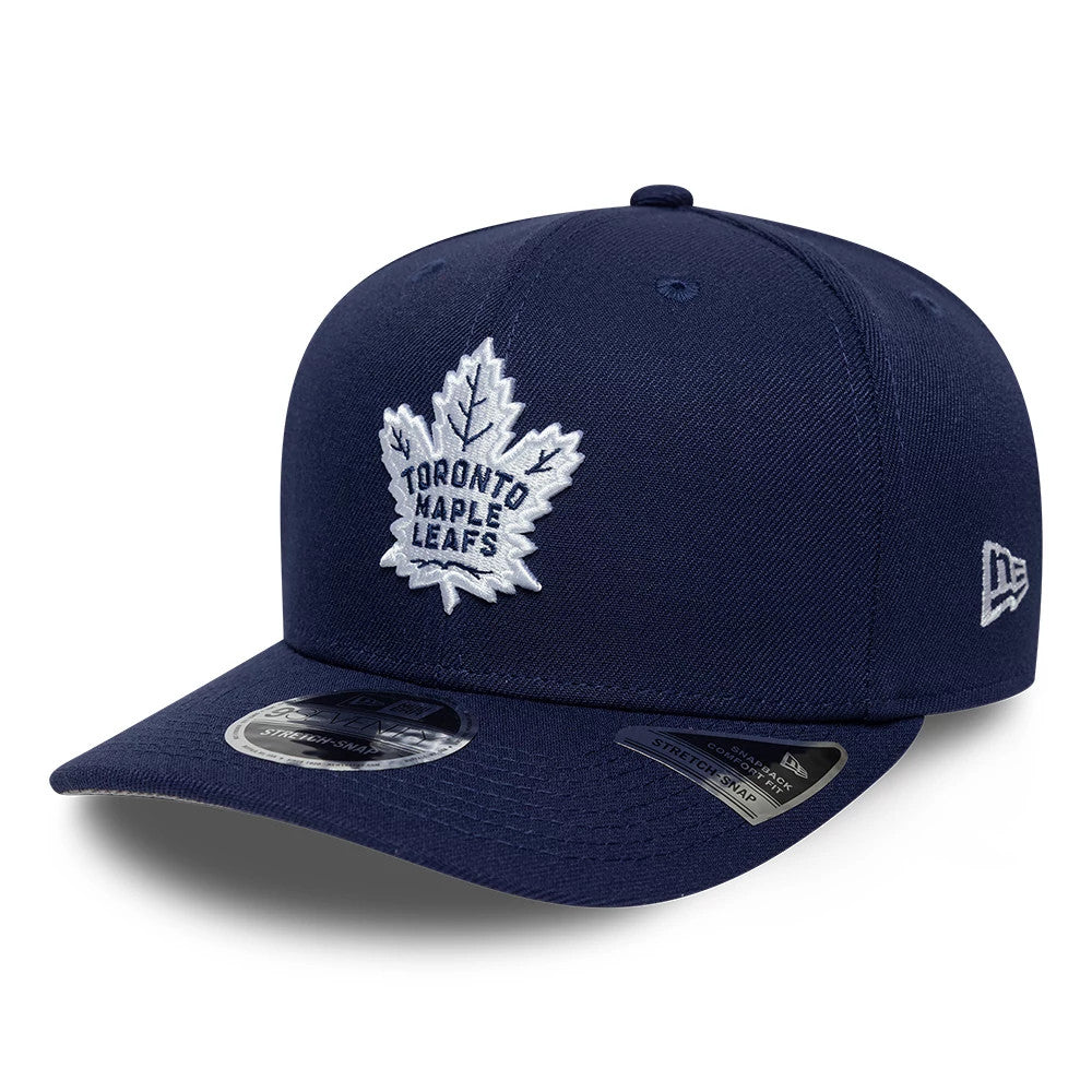 Toronto Maple Leafs NHL Team Navy New Era 9SEVENTY Stretch Snap Adjustable Cap, front view showing a raised white embroidered team logo on the front panel, a curved navy visor with a size sticker, and the New Era flag logo on the left side.