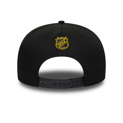 Boston Bruins NHL Team Black New Era 9SEVENTY Stretch Snap Adjustable Cap, rear view showing a yellow and white embroidered NHL logo shield centred on the back panels, with a black adjustable strap and the black structured crown.