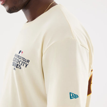 The model is wearing this MLB Mexico City Series 2026 Dueling Logo T-Shirt in Cream. 6